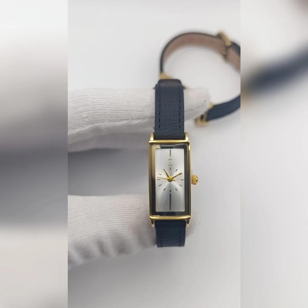 Montre IEKE Rectangulaire Bracelet Cuir Noir — Boîtier rectangulaire doré, bracelet en cuir noir, cadran blanc ou noir.